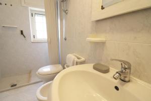 a white bathroom with a sink and a toilet at Casa Primus Torre Santo Stefano in Otranto +34 photos