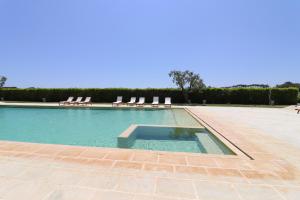 a pool with lounge chairs and a swimming pool at Casa Primus Torre Santo Stefano in Otranto