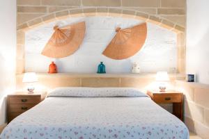 a bedroom with a bed with two night stands and two lamps at Villa Riggia in Nardò +135 photos