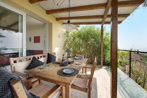 a wooden dining table and chairs on a patio at Villa Savi Lake View and Pool in Torri del Benaco