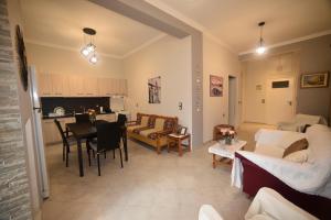 a living room with a couch and a table at Nicol apartment in Koustáros