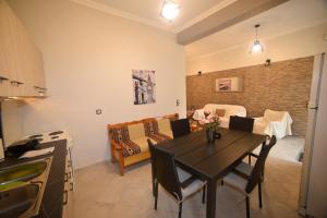 a kitchen and dining room with a table and a couch at Nicol apartment in Koustáros +13 photos