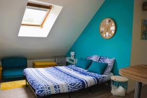 a bedroom with a bed and a clock on the wall at le Nid perché in Brou