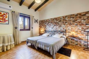 ein Schlafzimmer mit einem Bett und einer Steinwand in der Unterkunft Finca Esplendor in Campos + 18 Fotos