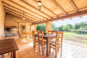 a dining room with a table and chairs at S' Oratge in Islas Baleares