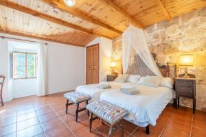a bedroom with two beds and two chairs at S' Oratge in Islas Baleares +36 photos