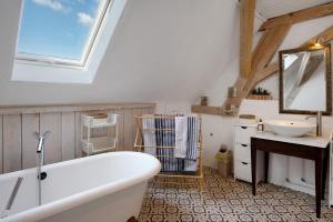 a bathroom with a white tub and a sink at Ferienappartments Nähe Schweiz in Kandern +70 photos