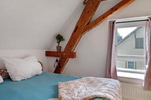 a bedroom with a bed and a window at Ferienappartments Nähe Schweiz in Kandern