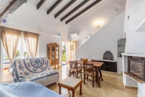 a living room with a table and a fireplace at Cala Serena Beach in Felanitx
