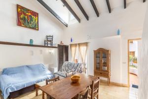 a living room with a bed and a table at Cala Serena Beach in Felanitx