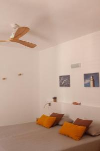 a living room with a couch with orange pillows at Vivendes Adelina - Escapada Formentera in Es Pujols