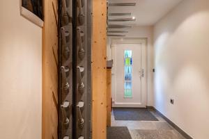 a hallway with a wall of wine racks at Stoffel Apartments Martina in Selva