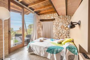 a bedroom with a bed and a large window at El Cobert De Lera in Oden