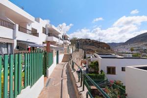 a view of a street with white buildings at Jolly suite puertorico Beach in Mogán