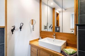 a bathroom with a sink and a mirror at Gästehaus Wüpping 2 in Salem +16 photos