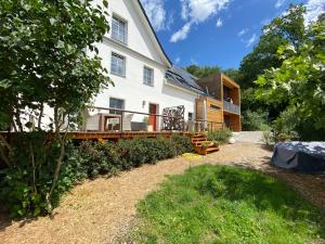 a large white house with a wooden deck at Gästehaus Wüpping 2 in Salem