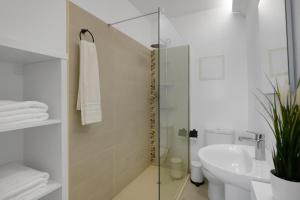 a bathroom with a shower and a toilet and a sink at Dúplex El Equilibrio in Playa Honda +21 photos