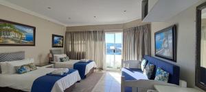 a hotel room with two beds and a window at The White House Guesthouse in East London +106 photos