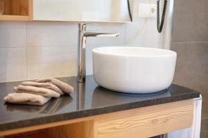 a bathroom counter with a sink and two towels at Teutenhofer Apfel in Feldthurns +13 photos