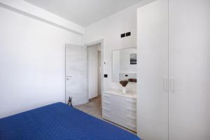 a bedroom with white cabinets and a blue bed at Antichi Ricordi - Il Pollaio in Marina di Andora +24 photos