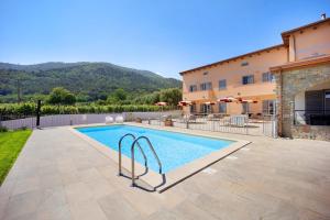 a swimming pool in front of a building at Antichi Ricordi - Il Pollaio in Marina di Andora