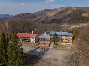 an aerial view of a building in the mountains at Penzion Tesák-ČERŇAVA in Chvalčov