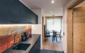 a kitchen with a sink and a counter top at Lichtung Woldererhof Sonnenlicht in Racines