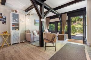 a living room with a couch and a chair at Wohnen im Heidehaus in Sankt Dionys