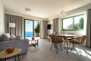 a living room with a couch and a table and chairs at Joy Aqua in Skala