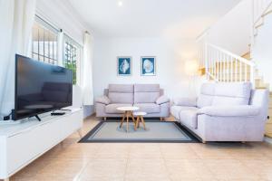 a living room with two couches and a flat screen tv at Casa Mar in Vinarós