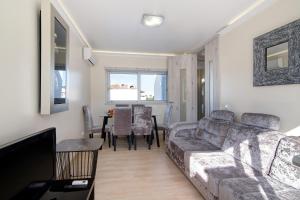 a living room with a couch and a table at Numar Residence Villa X in Manta Rota