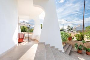 a view from the balcony of a house with white walls at I 4 Venti in Melendugno