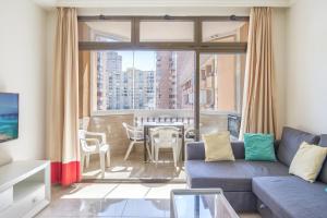 a living room with a couch and a table at Marina view sunny apartment in Fuengirola