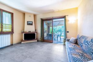 a living room with a couch and a television at Casa Caterina con giardino in Marone