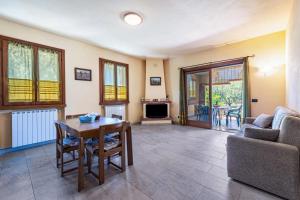 a living room with a table and a couch at Casa Caterina con giardino in Marone
