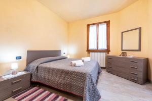 a bedroom with a bed with two towels on it at Casa Caterina con giardino in Marone