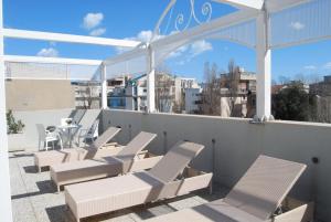 a group of chairs and tables on a roof at Hotel Residence Villa Del Mare in Rimini