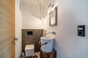 a bathroom with a sink and a mirror at vinum - schlosserhaus 31 in Tesimo +8 photos
