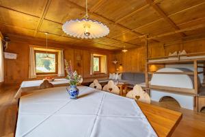 a dining room with a table and a bunk bed at Ferienhaus Oberschneider in Selva dei Molini