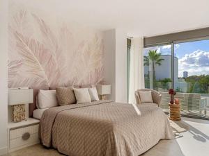 a bedroom with a large bed and a large window at Villa 11 Sunset in Marbella
