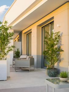 an outdoor patio with chairs and potted plants at Villa 11 Sunset in Marbella