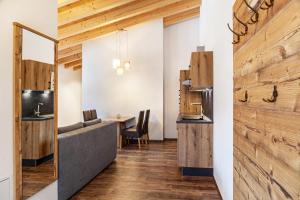 a meeting room with a table and chairs and a wooden wall at Ferienwohnung Wetterstein in Ehrwald +17 photos