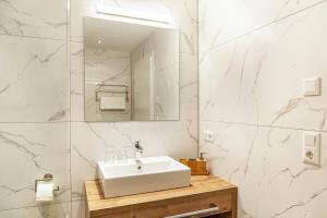 a white bathroom with a sink and a mirror at Ferienwohnung Wetterstein in Ehrwald