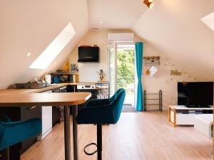 a kitchen with a table and chairs in a room at le Nid perché in Brou