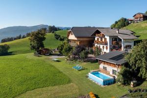 an aerial view of a house on a hill at Gschtraffhof in Kastelruth