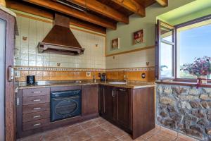 a kitchen with a sink and a stove at Paz y Tranquilidad in Melarde