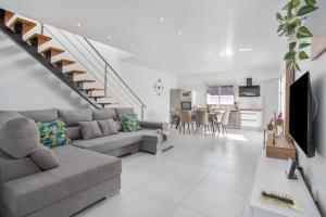 a living room with a couch and a staircase at Casa Gara Fuerteventura in Gran Tarajal