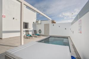 a house with a swimming pool on a roof at Casa Gara Fuerteventura in Gran Tarajal