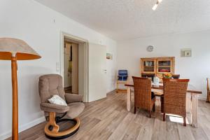 a living room with a chair and a table at Ferienwohnung Elim in Olsberg
