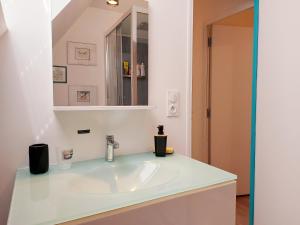 a bathroom with a sink and a mirror at le Nid perché in Brou +42 photos